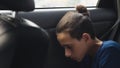 Close. Teenage boy sleeping in the back seat of car