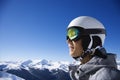 Teenage boy snowboarder in mountains.