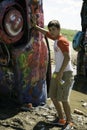 Teenage Boy Spray Painting a Car