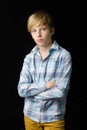 Teenage boy standing with folded hands