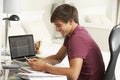 Teenage Boy Studying At Desk In Bedroom Using Mobile Phone Royalty Free Stock Photo