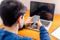 Teenage Boy Studying At Desk In Bedroom Using Mobile Phone Royalty Free Stock Photo