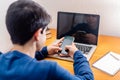 Teenage Boy Studying At Desk In Bedroom Using Mobile Phone Royalty Free Stock Photo