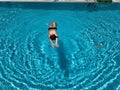 Teenage boy having joy in blue water of swimming pool Royalty Free Stock Photo