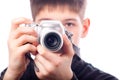 Teenage boy taking photos with small camera