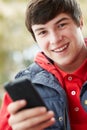 Teenage Boy Texting On Smartphone