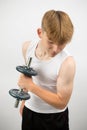 Teenage boy using a dumbbell Royalty Free Stock Photo