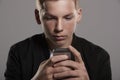 Teenage boy using mobile phone, head and shoulders, crop Royalty Free Stock Photo