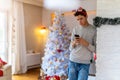 Teenage boy using mobile phone at home in Christmas time Royalty Free Stock Photo