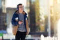 Teenage boy using smartphone and listening to music outdoors. Copy space Royalty Free Stock Photo