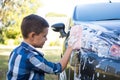 Teenage boy washing a car Royalty Free Stock Photo