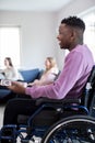 Teenage Boy In Wheelchair Watching Television With Freinds At Home Royalty Free Stock Photo