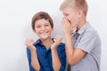 Teenage boy whispering in the ear a secret to Royalty Free Stock Photo