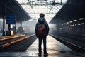 a teenage boy who ran away from home, scared, stands alone on the platform