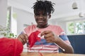 Teenage Boy With Wool Knitting On Table At Home Royalty Free Stock Photo