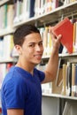 Teenage boy working in library Royalty Free Stock Photo