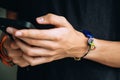 Teenage boy with wristlet with autism infinity rainbow symbol sign on his hand. World autism awareness day, autism