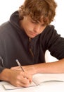 Teenage boy writing check Royalty Free Stock Photo