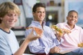 Teenage boys enjoying fast food lunches together