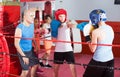 Teenage boys exercising at boxing with coach