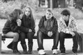 Teenage boys and girls having fun in autumn park Royalty Free Stock Photo