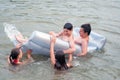 Teenage boys and girls swimming and playing in the river in summer