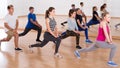 Teenage boys and girls with trainer stretching in dance hall Royalty Free Stock Photo