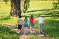 Teenage boys and girls walking in nature on sunny spring day Royalty Free Stock Photo