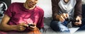 Teenage boys hanging out in a bedroom playing video games together Royalty Free Stock Photo