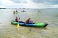 Teenage boys learning to paddle a kayak