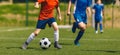 Teenage Boys Play Tournament Match in a Run Duel. Football Game on Summer Sunny Day