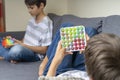 Teenage boys playing with rainbow pop-it fidget toys at home. Push pop-it fidgeting game helps relieve stress, anxiety