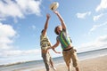 Teenage Boys Playing Rugby On Beach