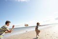 Teenage Boys Playing Rugby On Beach Together