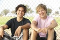 Teenage Boys Sitting In Playground Royalty Free Stock Photo