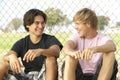 Teenage Boys Sitting In Playground Royalty Free Stock Photo