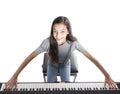 Teenage brunette girl and black upright piano in studio Royalty Free Stock Photo