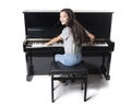 Teenage brunette girl and black upright piano in studio