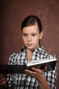 Brunette girl reading a book and looking amazed Royalty Free Stock Photo