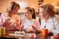 Teenage girl decorating Easter eggs with her mother and grandmother Royalty Free Stock Photo