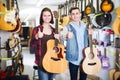 Teenage choosing best acoustic guitar