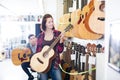 Teenage choosing best acoustic guitar