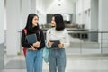 Teenage college friend students walking and chatting in college campus while having break after class. Two happy students walking Royalty Free Stock Photo