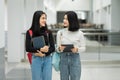 Teenage college friend students walking and chatting in college campus while having break after class. Two happy students walking Royalty Free Stock Photo