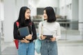 Teenage college friend students walking and chatting in college campus while having break after class. Two happy students walking Royalty Free Stock Photo