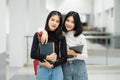 Teenage college friend students walking and chatting in college campus while having break after class. Two happy students walking Royalty Free Stock Photo