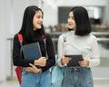 Teenage college friend students walking and chatting in college campus while having break after class. Two happy students walking Royalty Free Stock Photo