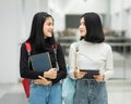 Teenage college friend students walking and chatting in college campus while having break after class. Two happy students walking Royalty Free Stock Photo