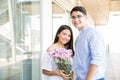 Teenage Couple With Flower Bouquet Dating In Shopping Mall