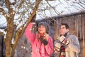 Teenage Couple Hanging Fairy Lights In Tree